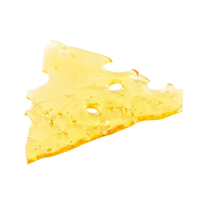Blue Dream shatter, a form of cannabis concentrate with yellow-amber hue and glass-like texture on white background.