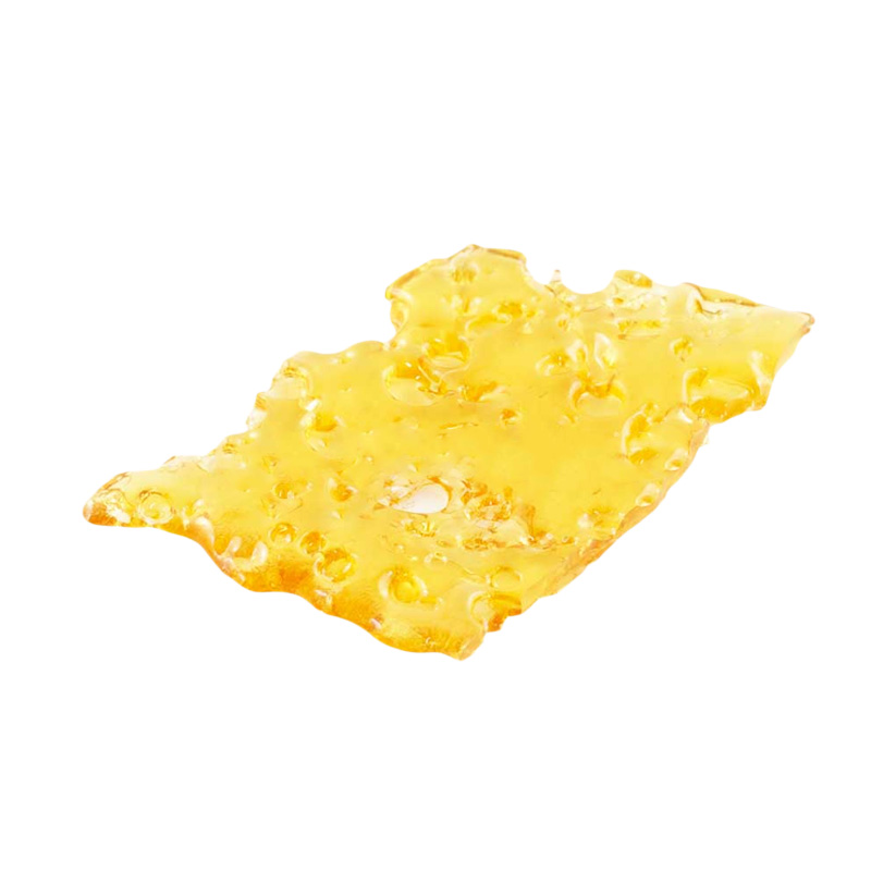 Pink Kush shatter, a form of cannabis concentrate with yellow-amber hue and glass-like texture on white background.